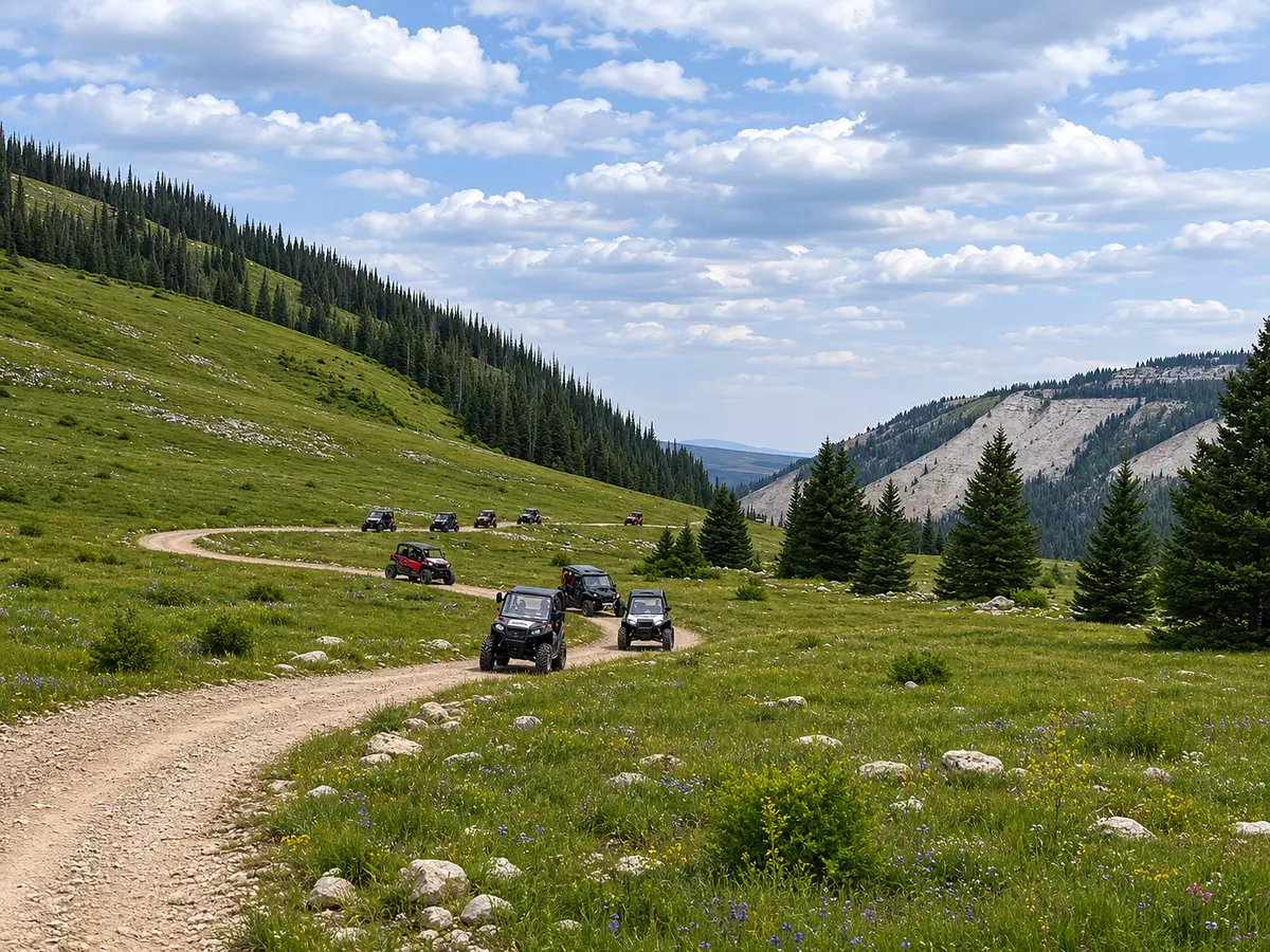 UTVs Driving across a mountain trail.